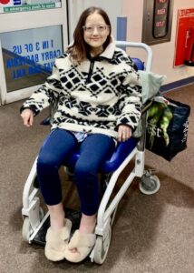 Lisa in a wheelchair outside a hospital