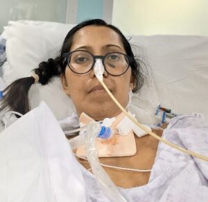 Sunita in intensive care with a tube coming out of her neck and another attached to her nose